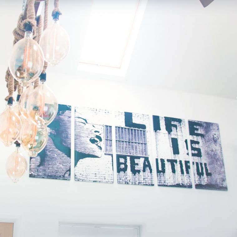 Jules' space with a picture on the wall reading life is beautiful.