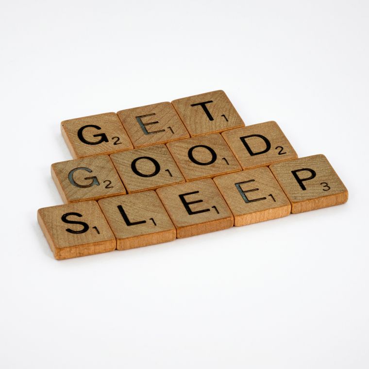 Scrabble blocks on a white background that read get good sleep.