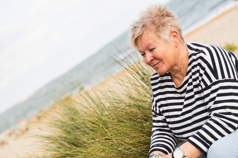 How To Supercharge Your Self Belief System Blog Image | Jules Whale Life Coach sitting on a sand dune in Dorset