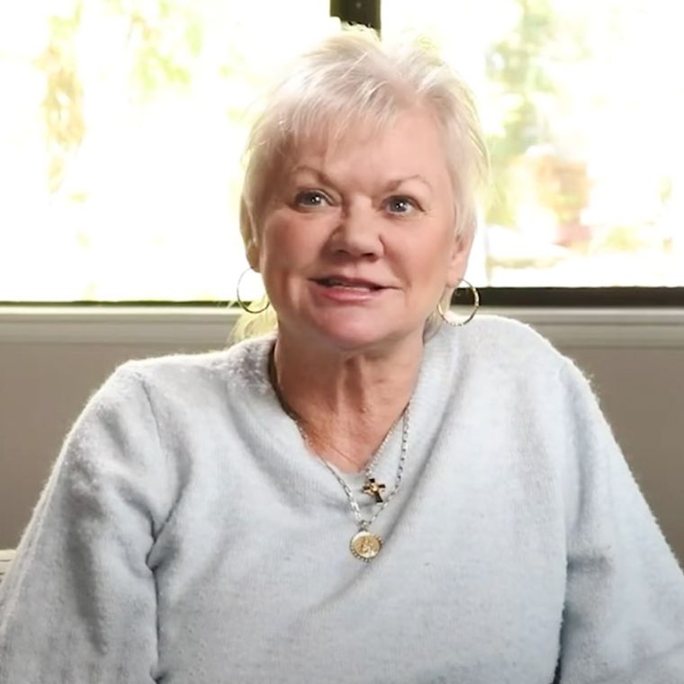 Portrait of a women wearing a grey jumper.