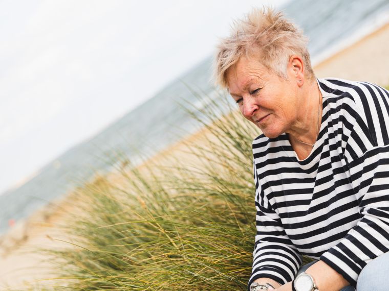 How To Supercharge Your Self Belief System Blog Image | Jules Whale Life Coach sitting on a sand dune in Dorset